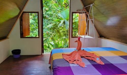a bedroom with a bed with a dress on it at Chalets Silencio del Bosque in Fortuna