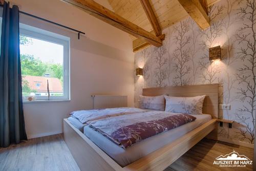 sypialnia z dużym łóżkiem i oknem w obiekcie Auszeit im Harz - Haus 2 Wohnung 5 w mieście Schierke