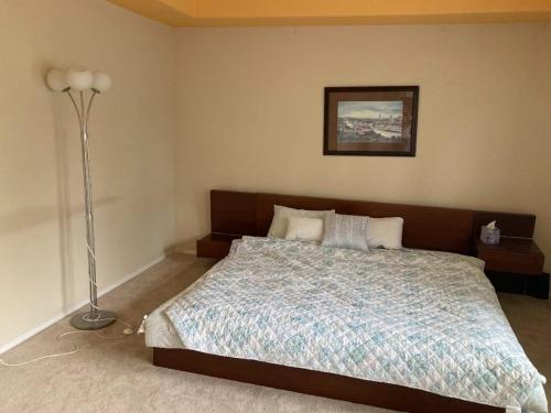 a bedroom with a bed and a lamp in it at Home sweet home in Hillsboro