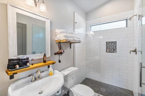 a bathroom with a toilet and a sink and a mirror at 7A Ranch in Wimberley