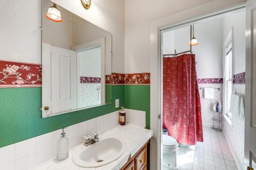 a bathroom with a sink and a red shower curtain at Stylish Sacramento Retreat Less Than 1 Mi to Downtown! in Sacramento