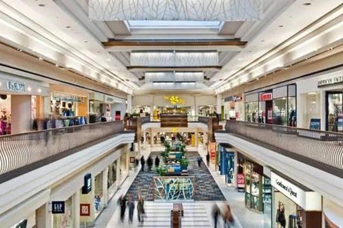 a large shopping mall with people walking through it at Stylish 2BR: w/free parking & streaming! in Pickering