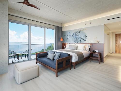 a bedroom with a bed and a couch and a balcony at Hyatt Vivid Grand Island in Cancún