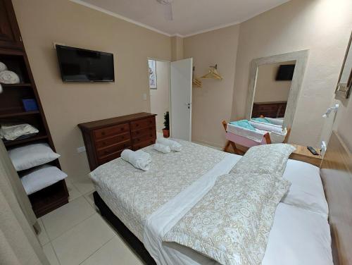 a bedroom with two beds and a mirror at Hermoso Dpto Temporario VaSan con cochera in Corrientes