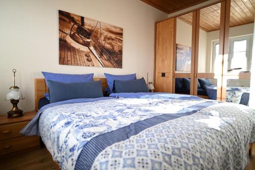 a bedroom with a bed with a blue and white comforter at Ferienwohnung Veras Kate in Greetsiel