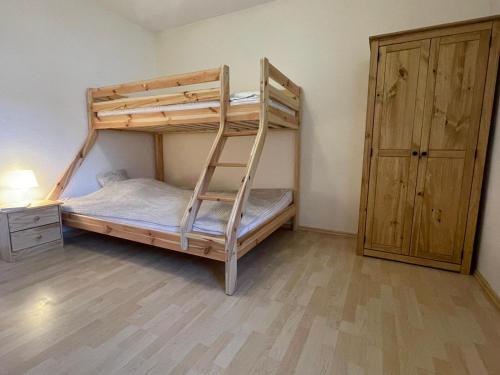 a bunk bed with a ladder in a room at Immensee App H in Ehst