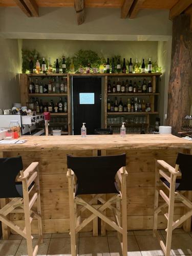 a large wooden bar with chairs in a kitchen at Σκίουρος in Neráïda
