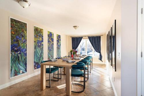 a long dining room with a long table and chairs at Downtown Denver: 4bd - Game/Movie Room - Backyard in Arvada