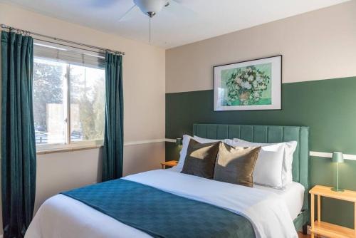 a bedroom with a large bed and a window at Downtown Denver: 4bd - Game/Movie Room - Backyard in Arvada