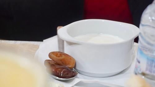 two donuts sitting next to a cup of milk at Résidence America in Dakhla