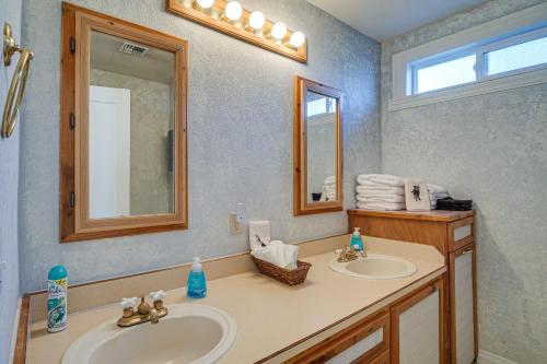 a bathroom with two sinks and a mirror at Peaceful Klamath Falls Home with Large Fenced Yard! in Klamath Falls