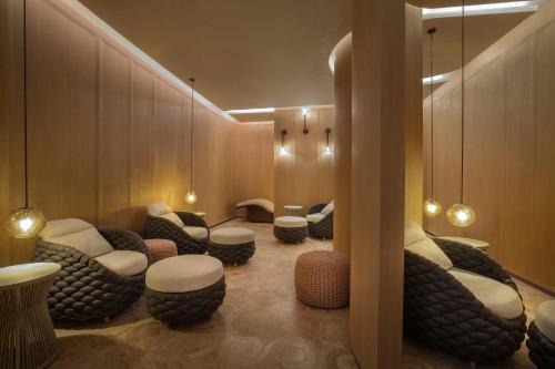 a waiting room with couches and chairs and lights at The St. Regis Red Sea Resort in Ḩanak