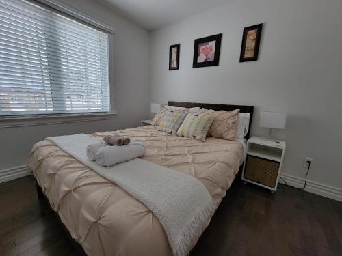 a bedroom with a large bed with a teddy bear on it at Le Cozy Clover in Moncton