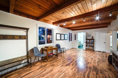 a living room with wooden ceilings and a table and chairs at Snowline Cabin 66 - Hot Tub - Wi-Fi - 3 Bedroom - Sleeps 10 in Deming