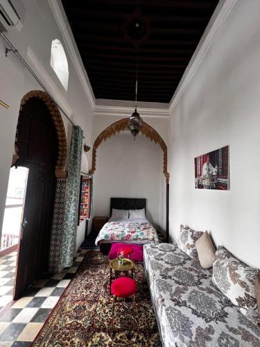 a living room with a bed and a couch at Riad Palais D'Or in Rabat