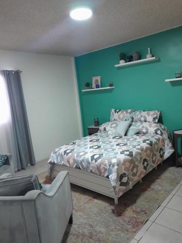 a bedroom with a bed and a chair at Casa de Ana in Tijuana