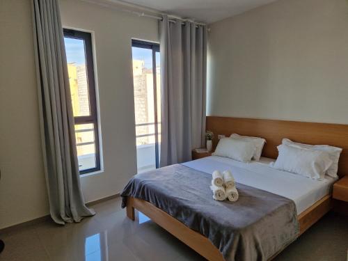 Ένα ή περισσότερα κρεβάτια σε δωμάτιο στο Apartamentos Beira-Mar