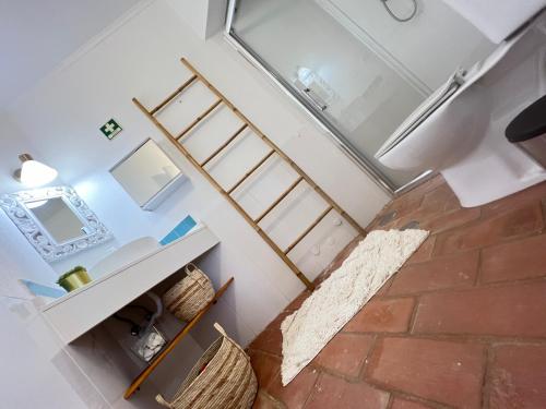 a view of a room with a bed and a bathroom at Casa46 in Olhão