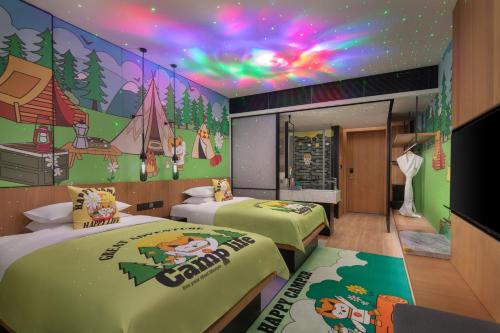 a room with two beds with a mural on the wall at Fairfield by Marriott Bijie in Bijie