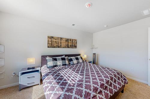a bedroom with a bed with a purple bedspread at Eternal Sunshine in Dover
