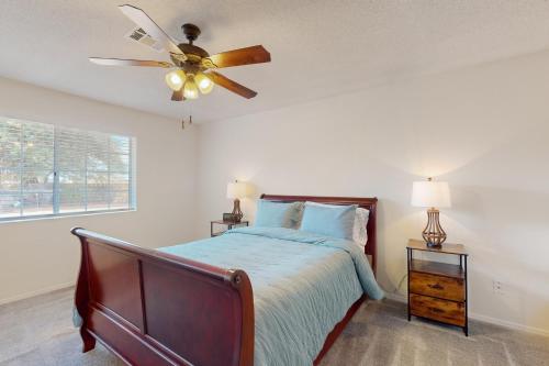 a bedroom with a bed and a ceiling fan at Heritage Hideaway in Yuma