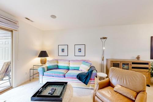 a living room with a couch and a chair at Plantations East - 166 Lakeside Dr in Lewes