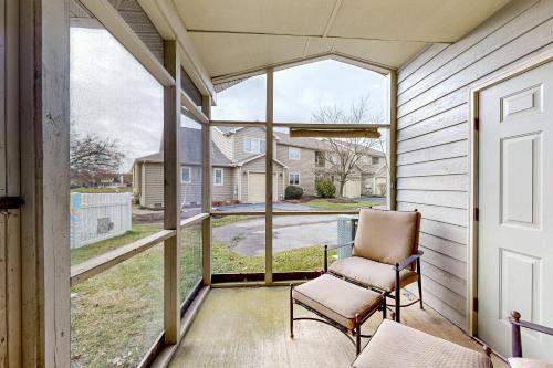 a screened porch with a chair and a window at Plantations East - 166 Lakeside Dr in Lewes