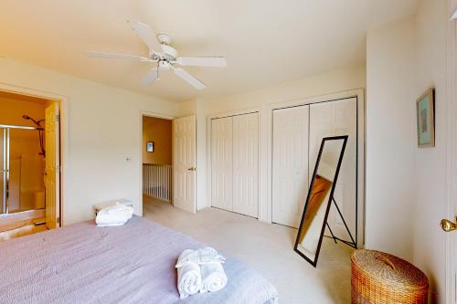 a bedroom with a bed and a ceiling fan at Plantations East - 166 Lakeside Dr in Lewes