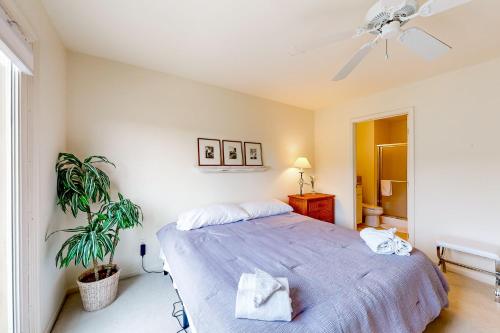 a bedroom with a bed and a ceiling fan at Plantations East - 166 Lakeside Dr in Lewes