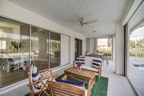 a living room with a couch and chairs on a porch at Port St Lucie Canal-Front Home with Heated Pool! in Port Saint Lucie