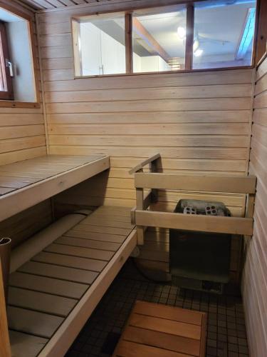 a sauna with wooden steps and a window at Loma-asunto Tahkon ytimessä in Kuopio