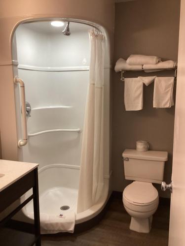 a bathroom with a tub and a toilet and a shower at Motel 6-Reno, NV - Livestock Events Center in Reno