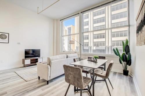 a living room with a table and a couch at CozySuites - 2BR with Direct Skybridge Access #3 in Indianapolis