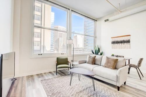 a living room with a couch and a table at CozySuites - 2BR with Direct Skybridge Access #3 in Indianapolis