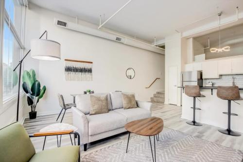 a living room with a couch and a table at CozySuites - 2BR with Direct Skybridge Access #3 in Indianapolis