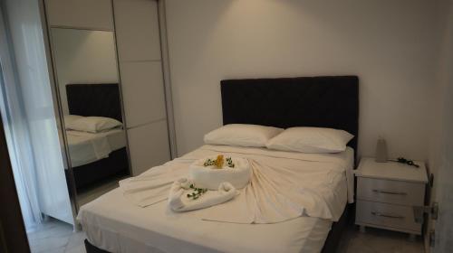 a bedroom with a bed with towels on it at Villa Dream Kuşadası Pool- Garage in Kuşadası