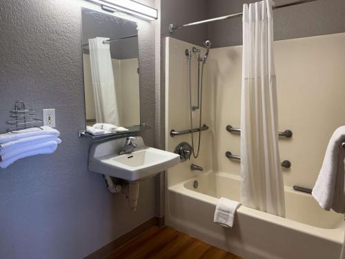 a bathroom with a sink and a shower and a tub at Motel 6-Simi Valley, CA in Simi Valley