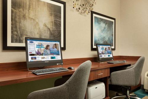 a desk with two computers sitting on top of it at Hampton Inn Denville-Rockaway-Parsippany in Denville