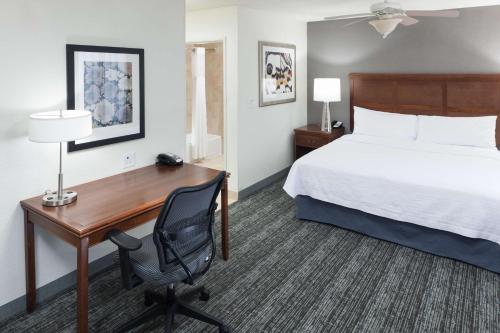 a hotel room with a desk and a bed at Homewood Suites by Hilton El Paso Airport in El Paso