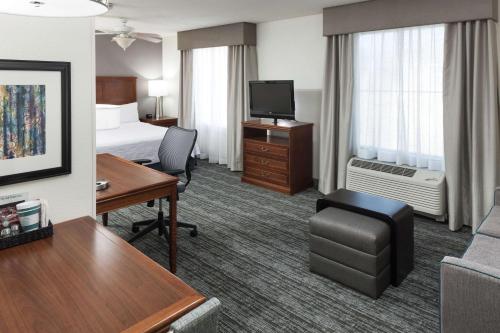 a hotel room with a bed and a desk at Homewood Suites by Hilton El Paso Airport in El Paso