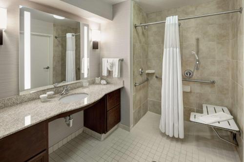 a bathroom with a shower and a sink and a shower curtain at Homewood Suites by Hilton El Paso Airport in El Paso