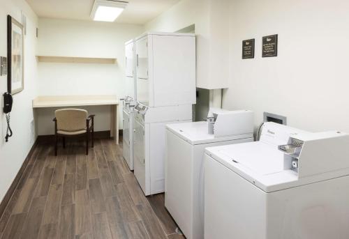 a laundry room with white appliances and a table at Homewood Suites by Hilton El Paso Airport in El Paso
