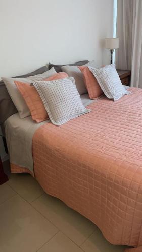 a bed with several pillows on top of it at Palermo Soho Apartment Guemes in Buenos Aires