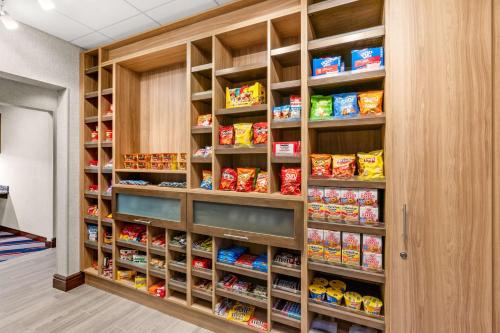 a food pantry with wooden shelves filled with food at Hampton Inn & Suites Fairbanks in Fairbanks