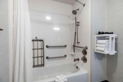 a white bathroom with a tub and a shower at Hampton Inn Fort Collins in Fort Collins