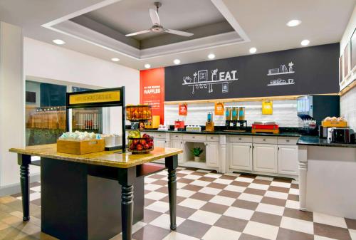 a large kitchen with a counter in a restaurant at Hampton Inn Ft Lauderdale Airport North Cruise Port in Fort Lauderdale