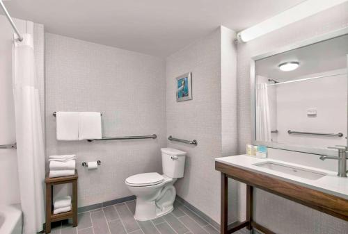 a bathroom with a toilet and a sink at Hampton Inn Ft Lauderdale Airport North Cruise Port in Fort Lauderdale