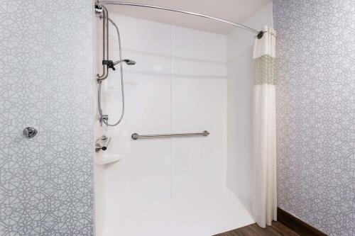 a shower with a glass door in a bathroom at Hampton Inn Commercial Boulevard-Fort Lauderdale in Tamarac