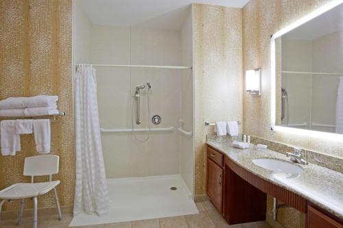 a bathroom with a shower and a sink at Homewood Suites by Hilton Sioux Falls in Sioux Falls