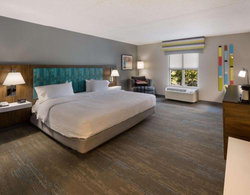 a hotel room with a large bed and a window at Hampton Inn and Suites Fredericksburg in Fredericksburg